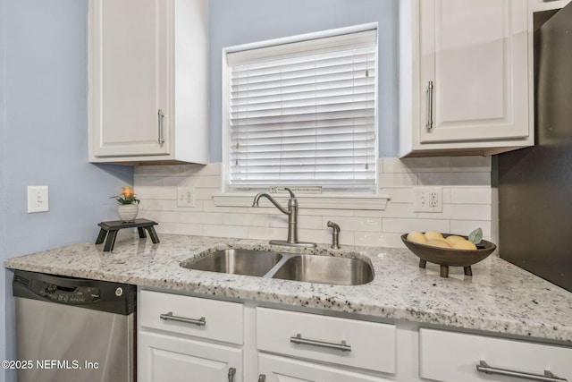 1020 Candlebark Dr, Jacksonville, FL 32225 - kitchen with dishwasher, white cabinetry, tasteful backsplash, and light stone counters