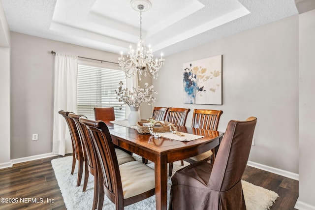 1020 Candlebark Dr, Jacksonville, FL 32225 - dining area with a chandelier, a raised ceiling, and dark wood-type flooring