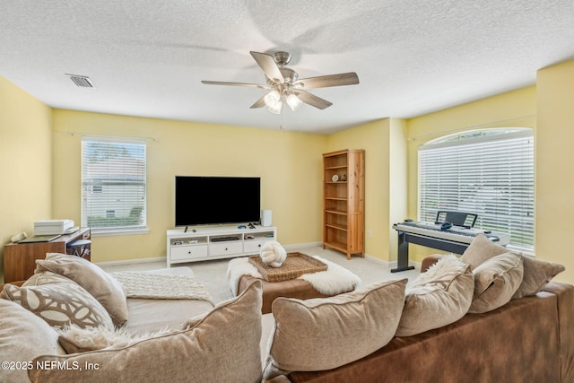 1020 Candlebark Dr, Jacksonville, FL 32225 - living area with a ceiling fan, carpet flooring, and a textured ceiling