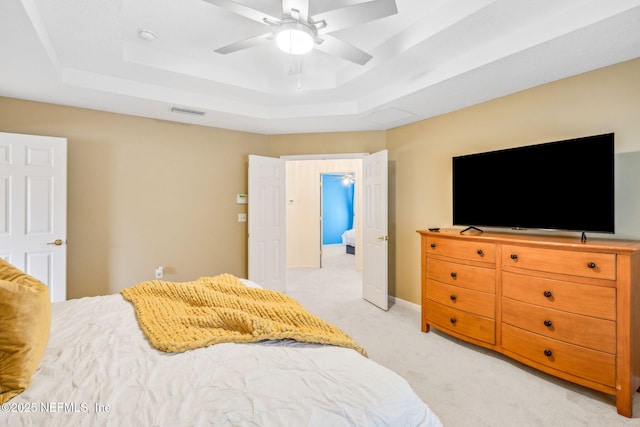 1020 Candlebark Dr, Jacksonville, FL 32225 - bedroom with a raised ceiling, light carpet, and a ceiling fan