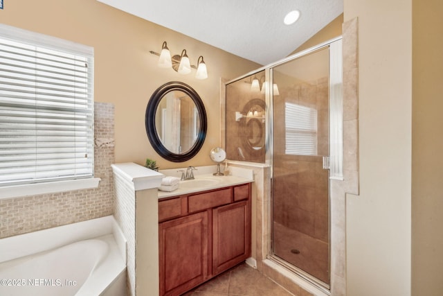 1020 Candlebark Dr, Jacksonville, FL 32225 - full bathroom featuring a shower stall, vanity, a garden tub, vaulted ceiling, and tile patterned flooring