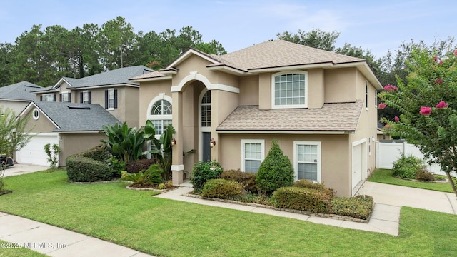 1020 Candlebark Dr, Jacksonville, FL 32225 - traditional-style home with concrete driveway, roof with shingles, stucco siding, and a garage