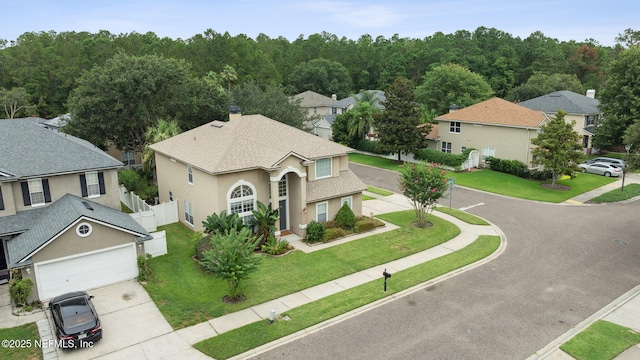 1020 Candlebark Dr, Jacksonville, FL 32225 - view of front of home with concrete driveway, stucco siding, a residential view, roof with shingles, and an attached garage