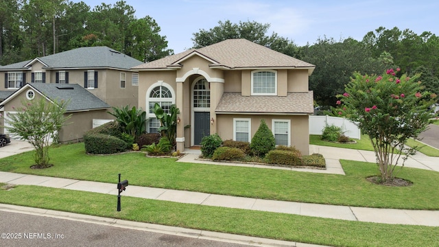 1020 Candlebark Dr, Jacksonville, FL 32225 - traditional home with stucco siding, roof with shingles, and concrete driveway