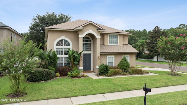 1020 Candlebark Dr, Jacksonville, FL 32225 - traditional-style house with stucco siding, a front yard, and a shingled roof