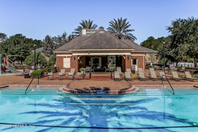 1020 Candlebark Dr, Jacksonville, FL 32225 - community pool featuring a patio area and an outbuilding