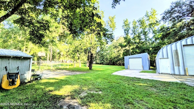 3822 County Road 220, Middleburg, FL 32068 - view of grassy yard featuring an outbuilding, view of wooded area, and a garage