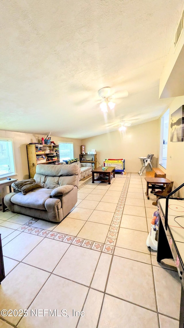 3822 County Road 220, Middleburg, FL 32068 - living area featuring light tile patterned floors, a ceiling fan, and a textured ceiling