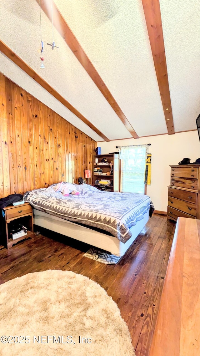 3822 County Road 220, Middleburg, FL 32068 - bedroom featuring beamed ceiling, wood-type flooring, wood walls, and a textured ceiling