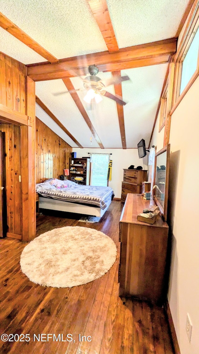 3822 County Road 220, Middleburg, FL 32068 - bedroom featuring wood finished floors, wood walls, a textured ceiling, and beamed ceiling