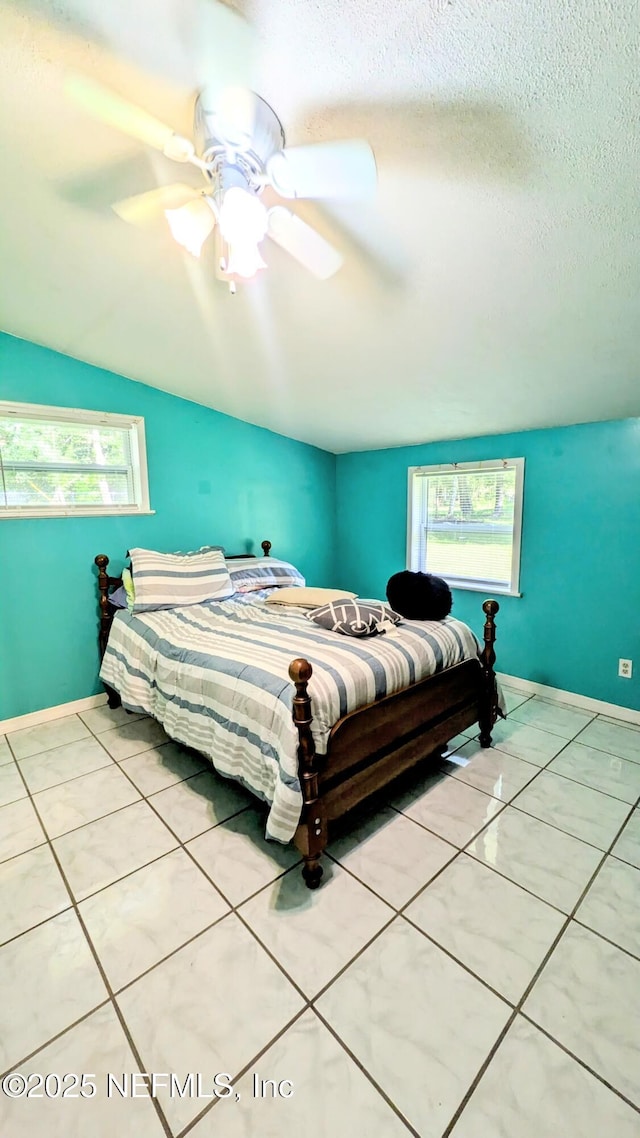3822 County Road 220, Middleburg, FL 32068 - bedroom featuring vaulted ceiling, a ceiling fan, a textured ceiling, and light tile patterned flooring