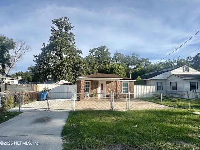 8300 Berry, Jacksonville, FL 32211 - view of front of house featuring a gate, brick siding, concrete driveway, and a fenced front yard