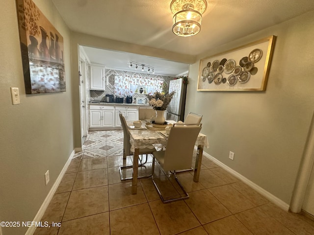 8300 Berry, Jacksonville, FL 32211 - dining room with tile patterned floors, a chandelier, and rail lighting