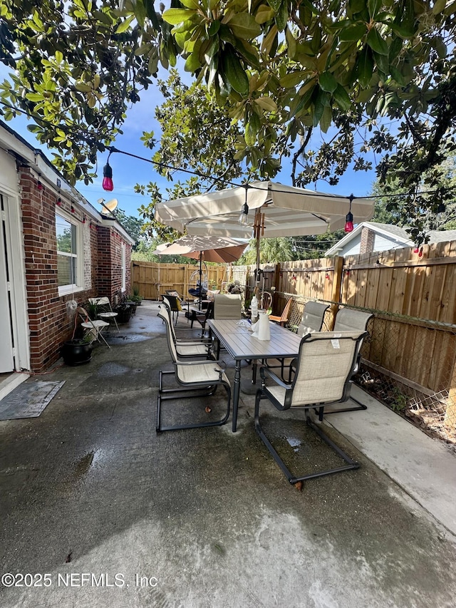 8300 Berry, Jacksonville, FL 32211 - fenced backyard featuring outdoor dining space and a patio