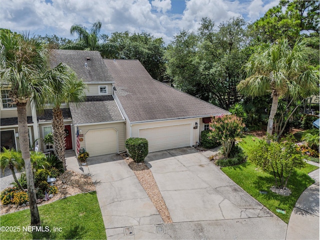 335 Sunrise Cir, Neptune Beach, FL 32266 - view of front of home with roof with shingles, concrete driveway, and a garage