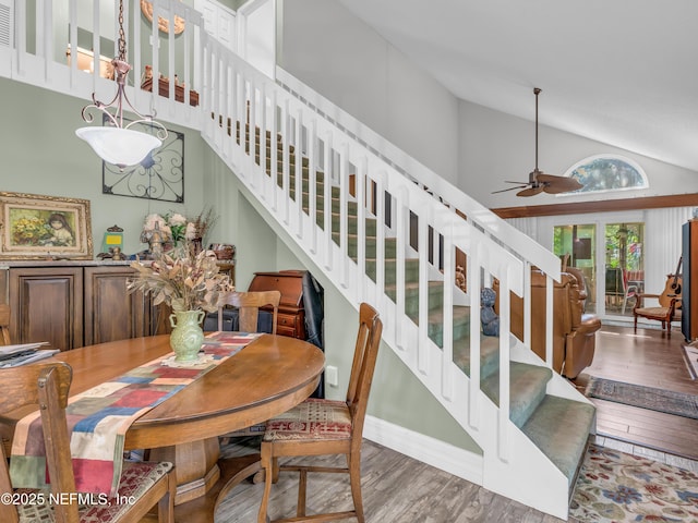 335 Sunrise Cir, Neptune Beach, FL 32266 - dining room with stairs, wood finished floors, a ceiling fan, and high vaulted ceiling