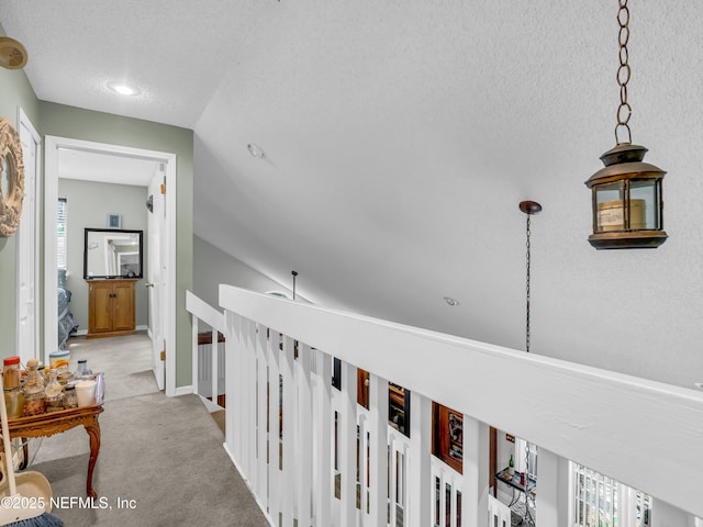 335 Sunrise Cir, Neptune Beach, FL 32266 - corridor featuring an upstairs landing, carpet flooring, and a textured ceiling