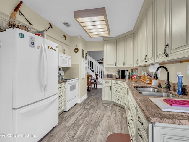 335 Sunrise Cir, Neptune Beach, FL 32266 - kitchen with white appliances and light wood finished floors