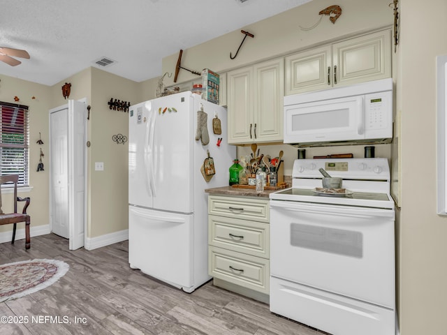 335 Sunrise Cir, Neptune Beach, FL 32266 - kitchen with white appliances, light wood-type flooring, and cream cabinetry