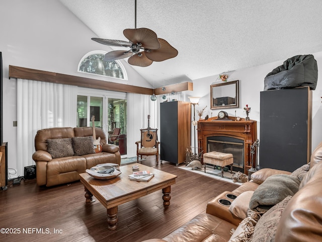 335 Sunrise Cir, Neptune Beach, FL 32266 - living area with a ceiling fan, a textured ceiling, a glass covered fireplace, wood finished floors, and high vaulted ceiling