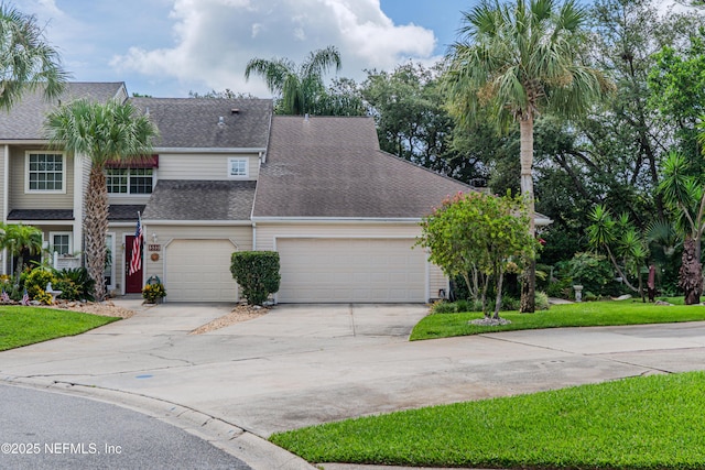 335 Sunrise Cir, Neptune Beach, FL 32266 - traditional home featuring driveway, roof with shingles, a front yard, and a garage