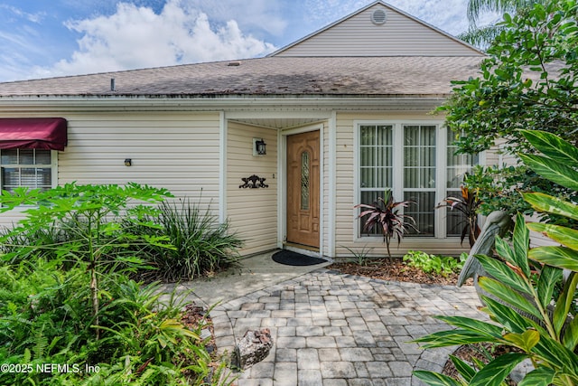 335 Sunrise Cir, Neptune Beach, FL 32266 - view of exterior entry with a shingled roof