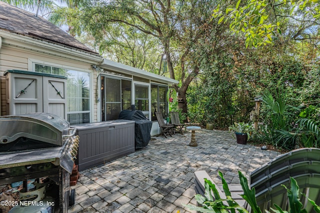 335 Sunrise Cir, Neptune Beach, FL 32266 - view of patio / terrace featuring a sunroom and grilling area