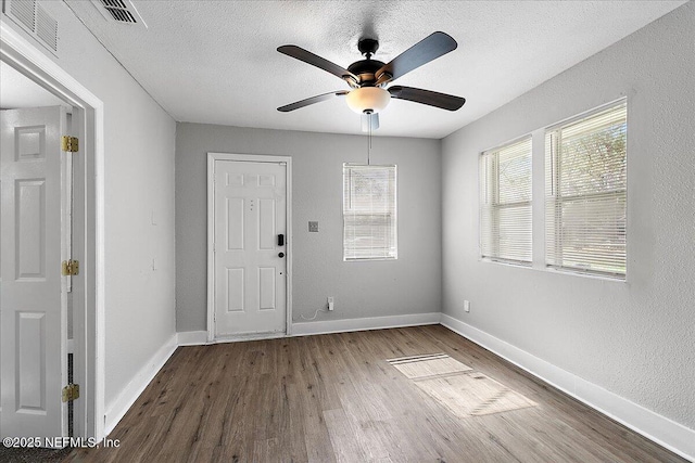 3607 Gilmore St, Jacksonville, FL 32205 - foyer entrance featuring wood finished floors, plenty of natural light, ceiling fan, and a textured ceiling