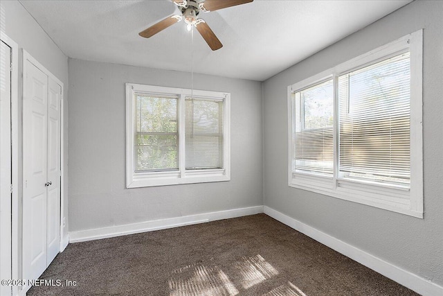 3607 Gilmore St, Jacksonville, FL 32205 - unfurnished bedroom with dark carpet, a closet, and ceiling fan