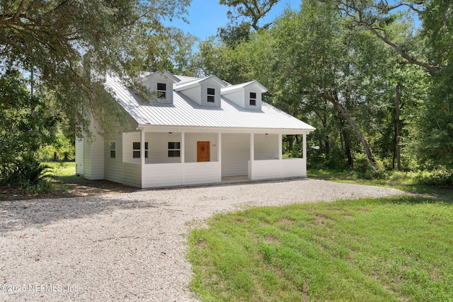 343 Tinsley Rd, Florahome, FL 32140 - view of front of house featuring gravel driveway, a metal roof, and a front yard