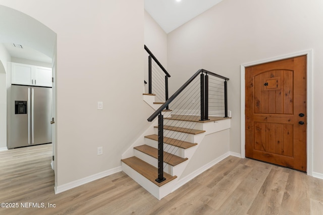 343 Tinsley Rd, Florahome, FL 32140 - entryway with light wood-style floors, stairs, and arched walkways