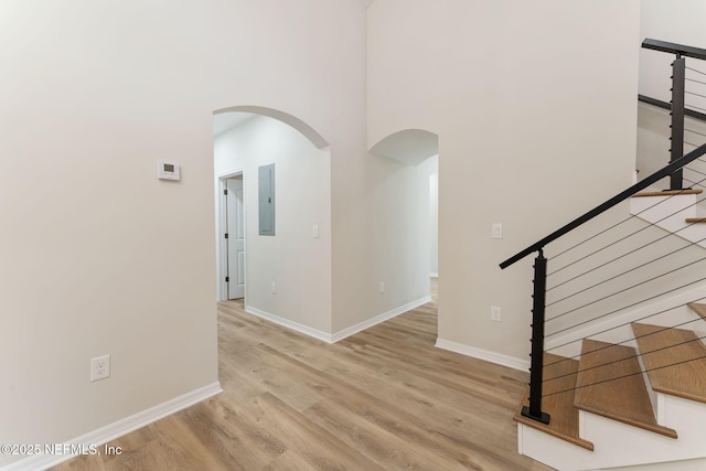 343 Tinsley Rd, Florahome, FL 32140 - stairway with arched walkways, wood finished floors, a high ceiling, and electric panel