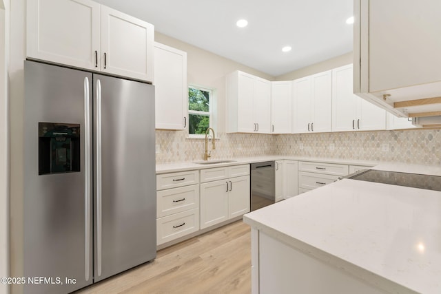 343 Tinsley Rd, Florahome, FL 32140 - kitchen featuring stainless steel appliances, decorative backsplash, light wood-style flooring, white cabinetry, and recessed lighting