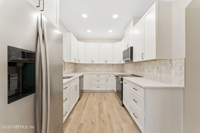 343 Tinsley Rd, Florahome, FL 32140 - kitchen with stainless steel appliances, light wood finished floors, light countertops, tasteful backsplash, and recessed lighting