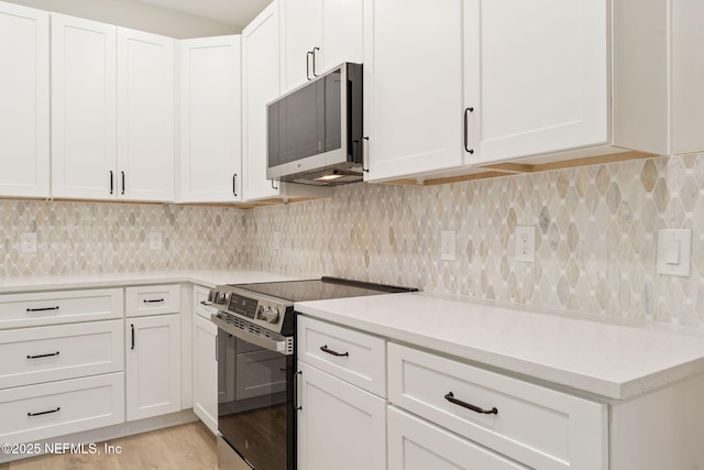 343 Tinsley Rd, Florahome, FL 32140 - kitchen featuring stainless steel appliances, light countertops, and white cabinets