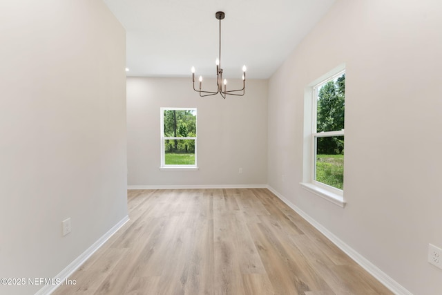343 Tinsley Rd, Florahome, FL 32140 - empty room featuring plenty of natural light, light wood finished floors, and a chandelier