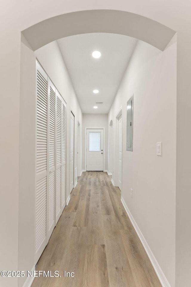 343 Tinsley Rd, Florahome, FL 32140 - corridor with electric panel, light wood-style flooring, arched walkways, and recessed lighting