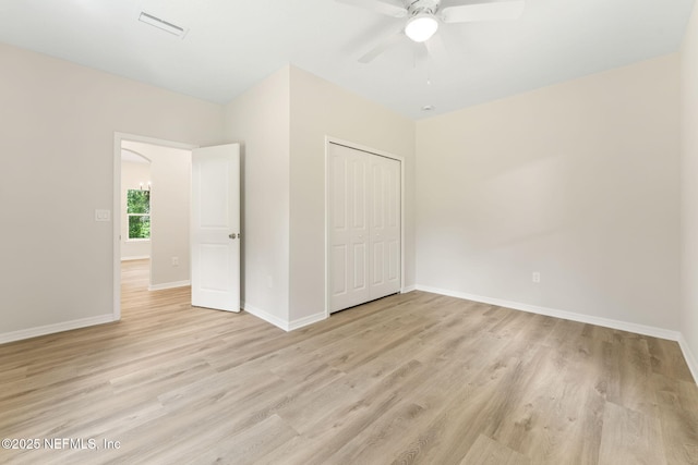 343 Tinsley Rd, Florahome, FL 32140 - unfurnished bedroom featuring light wood-style flooring, a closet, and a ceiling fan