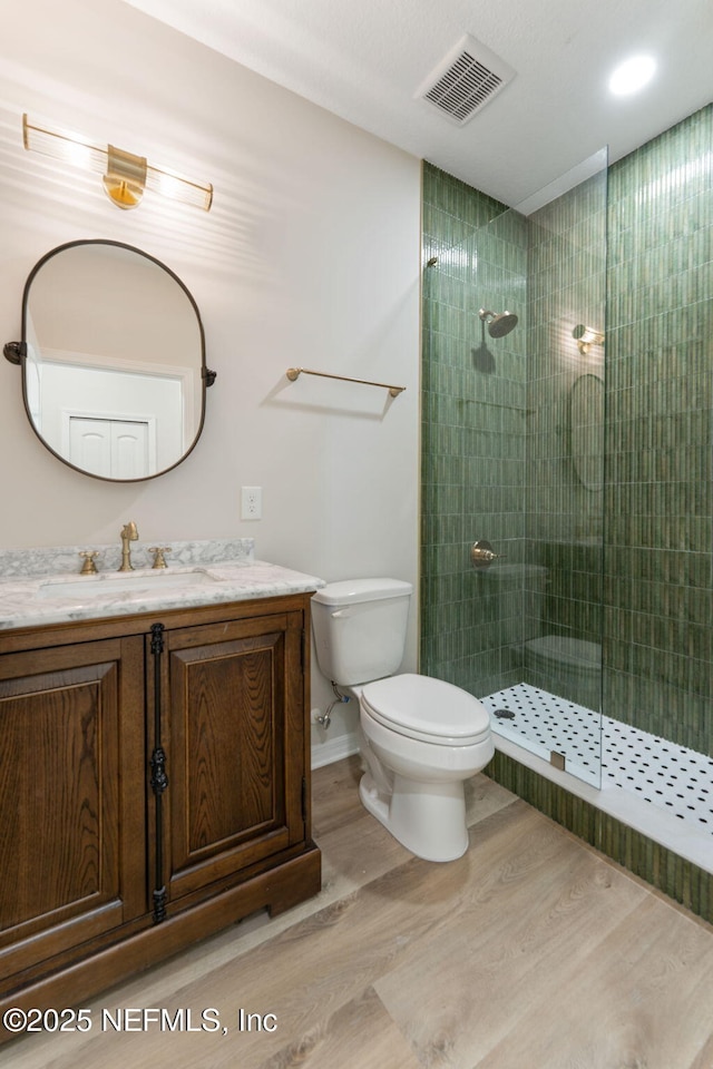 343 Tinsley Rd, Florahome, FL 32140 - full bathroom with wood finished floors, vanity, and tiled shower
