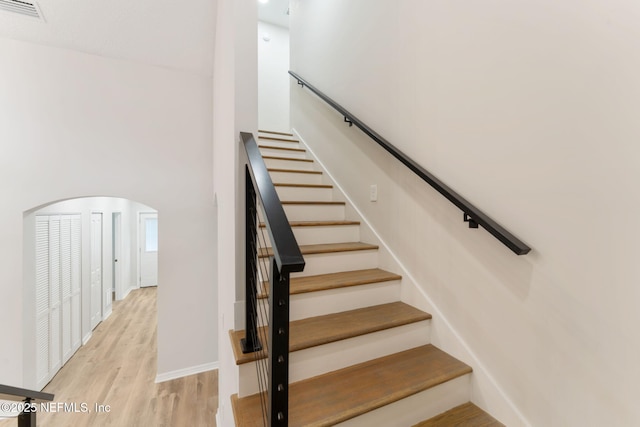 343 Tinsley Rd, Florahome, FL 32140 - stairway with a towering ceiling, arched walkways, and wood finished floors