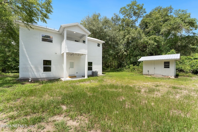 343 Tinsley Rd, Florahome, FL 32140 - rear view of property featuring a storage unit and a yard