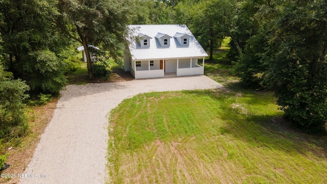 343 Tinsley Rd, Florahome, FL 32140 - cape cod-style house featuring a porch, driveway, and a metal roof