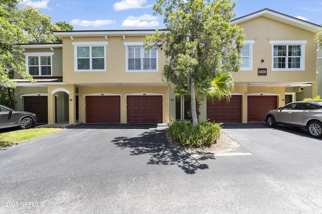 4000 Grande Vista Blvd Unit 15-106, Saint Augustine, FL 32084 - view of front of home featuring stucco siding, an attached garage, and driveway