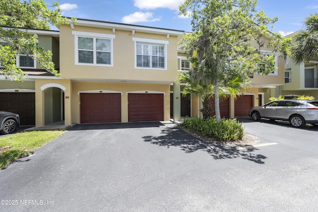 4000 Grande Vista Blvd Unit 15-106, Saint Augustine, FL 32084 - view of front of home with stucco siding, a garage, and driveway