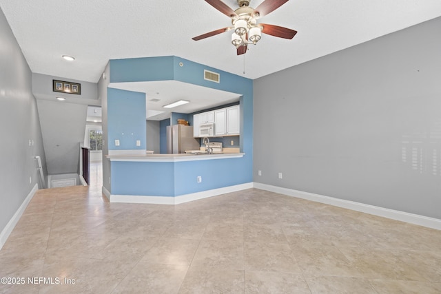 4000 Grande Vista Blvd Unit 15-106, Saint Augustine, FL 32084 - unfurnished living room featuring a ceiling fan and light tile patterned floors