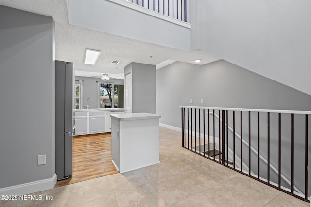 4000 Grande Vista Blvd Unit 15-106, Saint Augustine, FL 32084 - hallway with light tile patterned flooring, an upstairs landing, and a textured ceiling