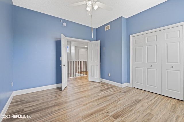 4000 Grande Vista Blvd Unit 15-106, Saint Augustine, FL 32084 - unfurnished bedroom featuring wood finished floors, a closet, a textured ceiling, and ceiling fan
