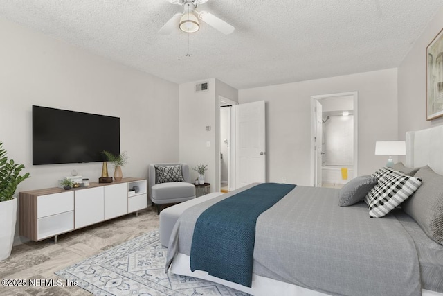1430 Spindrift Cir E, Neptune Beach, FL 32266 - bedroom with a textured ceiling, ensuite bath, and a ceiling fan