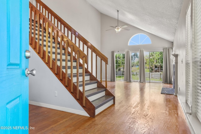 1430 Spindrift Cir E, Neptune Beach, FL 32266 - entryway with a ceiling fan, wood finished floors, a textured ceiling, stairway, and high vaulted ceiling
