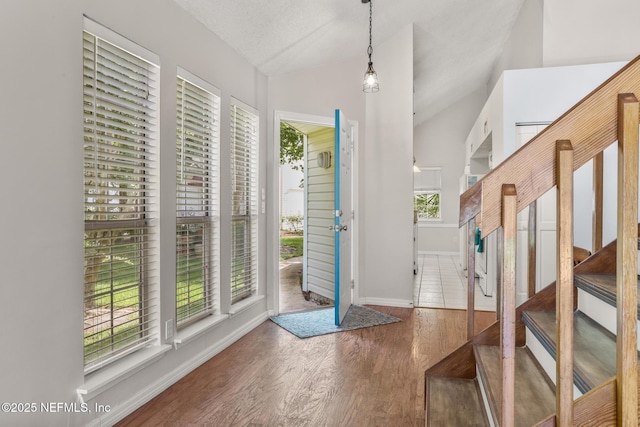 1430 Spindrift Cir E, Neptune Beach, FL 32266 - foyer with plenty of natural light, wood finished floors, and lofted ceiling